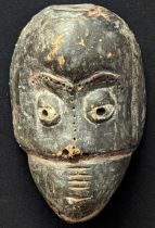 A Nigerian Ibibio African tribal carved wooden mask, Nigeria, 20th century,