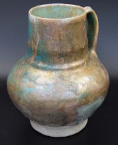A fine 11-12th century Syrian Raqqa turquoise glazed jug, H.18cm