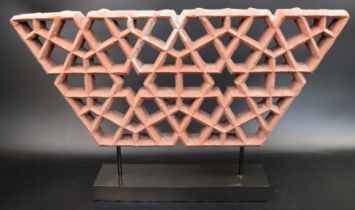 A fine 17th century Mughal Indian open worked red stone Jali panel on a stand, H.21cm W.48cm (