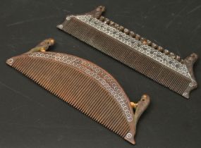 Two fine 19th century Indian silver inlaid carved wooden combs with birds finials, L.11.5cm