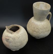 Two fine 12th century Persian Seljuk unglazed pottery jugs, H.20.5cm (largest)