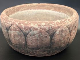 A finely carved 17th century Mughal Indian red stone lotus shaped bowl, D.28cm