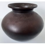 A bronze vase or water vessel, possibly Himalayan Indian or Chinese, H.15cm