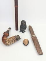 A Group of Oriental objects including a Tibetan flute, a pipe, a dagger, a Japanese miniature carved