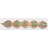 A 19th century Chinese gilded silver bracelet inset with jade stones, marked silver to interior,