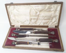 A silver collared antler handle carving set