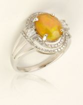 A Deco style opal and diamond ring, mounted on 18ct white gold, 4g