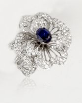 A floral style sapphire and diamond ring, 2.84cts oval cut with small VS diamonds, approx. 3.35cts