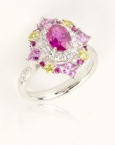 A ruby diamond and sapphire ring, central oval cut unheated 1.30cts Mozambique ruby, surrounded by a