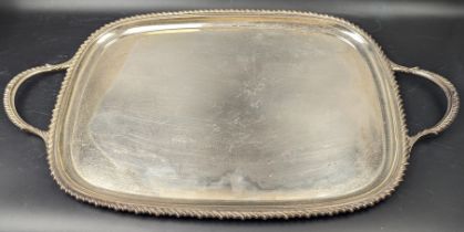 An early 20th century silver twin handled serving tray, hallmarked Sheffield, 1902, maker James