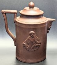 An unusual 18th century Continental clay teapot depicting a semi nude maiden to one side, a splay of