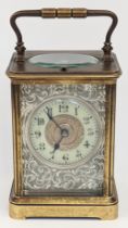 A late 19th century French carriage clock, silver embossed front
