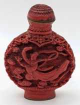 An early 20th century Chinese red lacquer snuff bottle depicting a maiden in robes, character