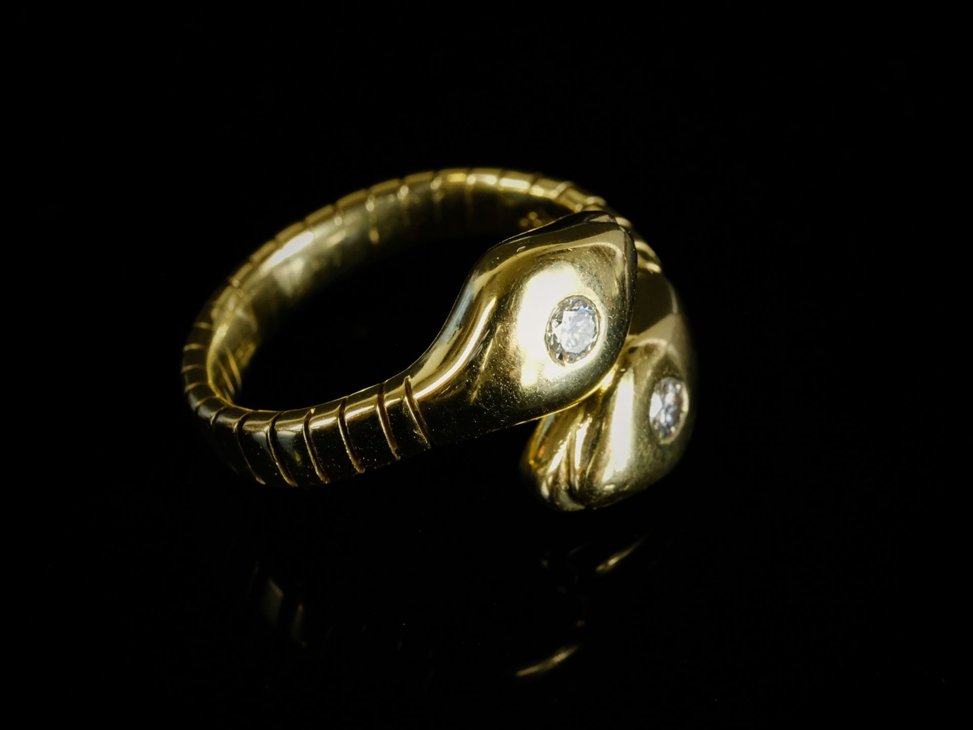 SNAKE RING set with a brilliant-cut diamond on each of the snakeheads, total around 0.30ct, approx.