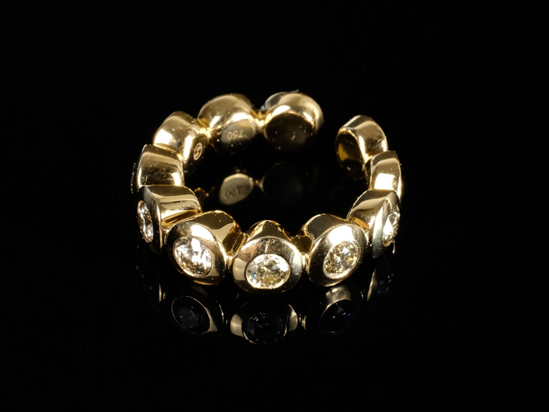 DESIGN RING consisting of eleven small cylinders, seven of them with set champagne diamonds, around