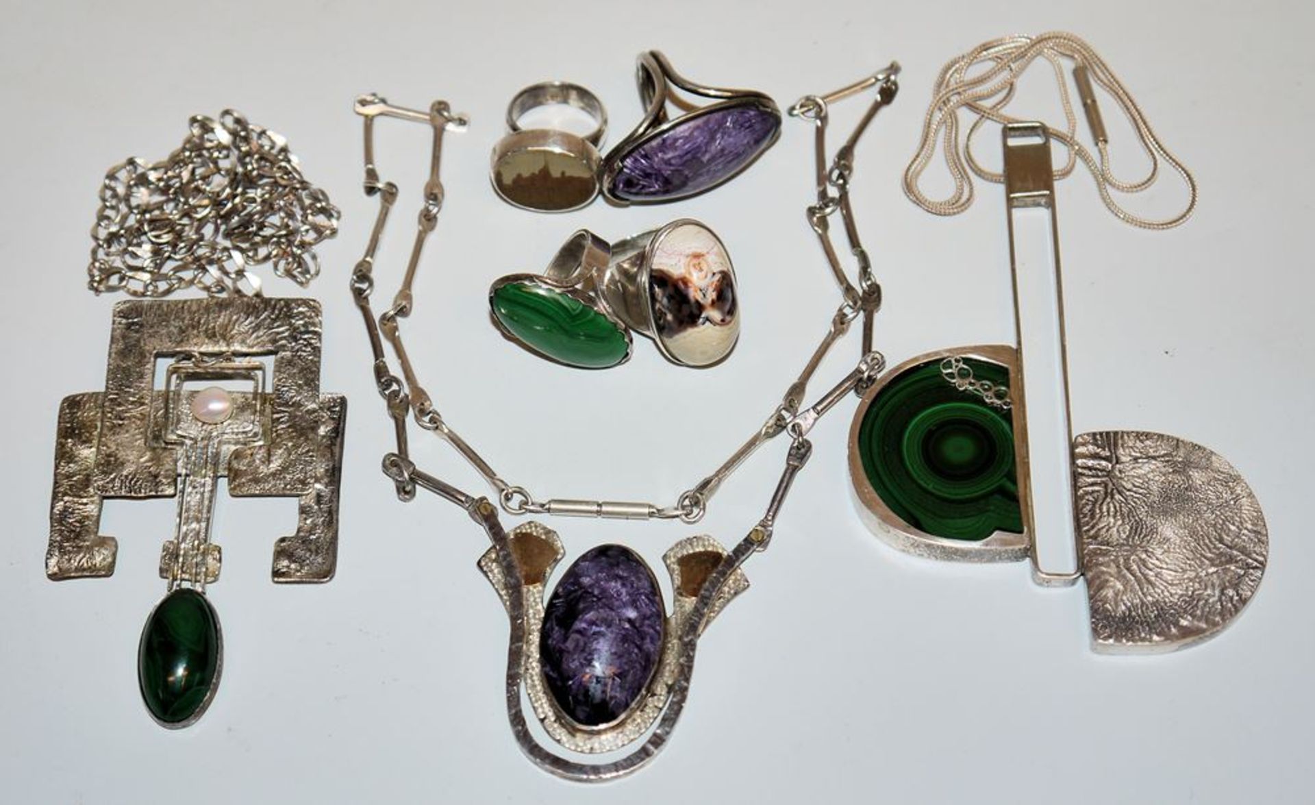 Three designer necklaces and four rings with amethyst, malachite, pearl, agate and landscape stone,