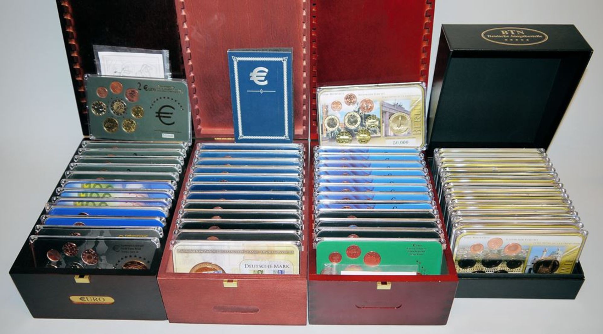 54 Euro coin sets with commemorative coins and medals