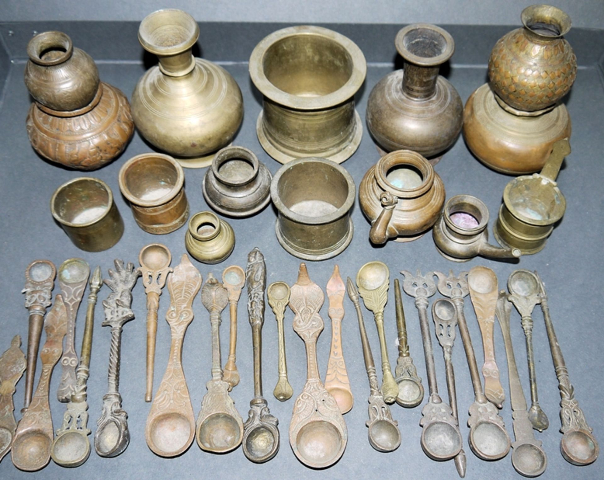 Collection of ritual spoons and holy water vessels of cast brass, India 18th & 19th c.