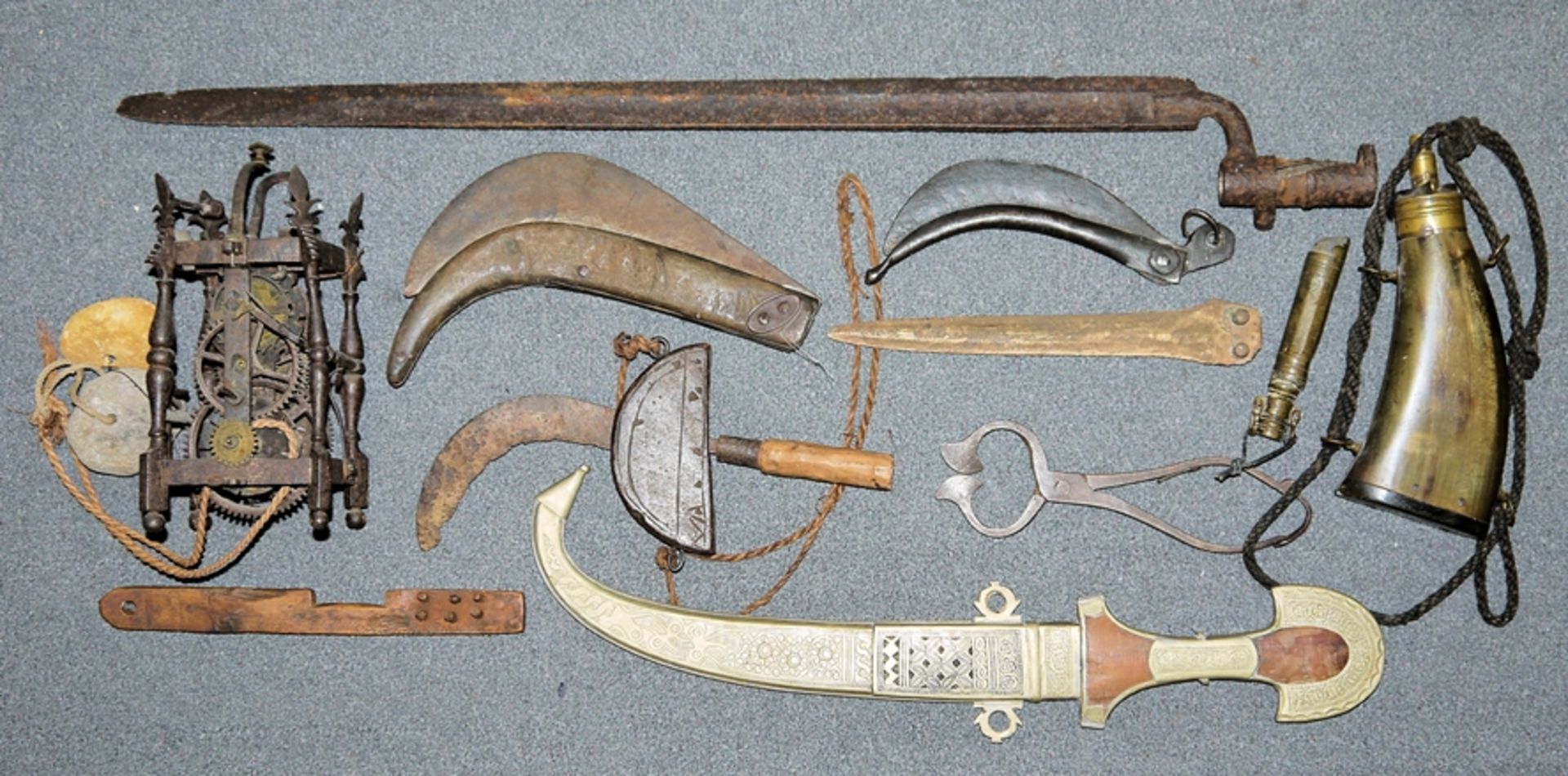 Collection of antique weapons, implements and a clockwork from the 18th century