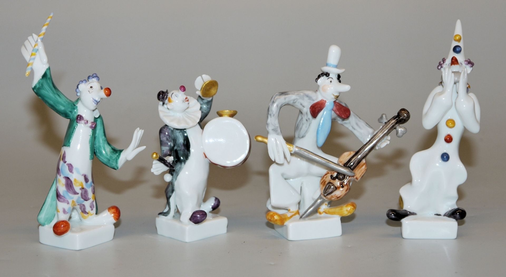 Four porcelain sculptures "Clown Band": conductor, drummer, harmonica player and double bass player