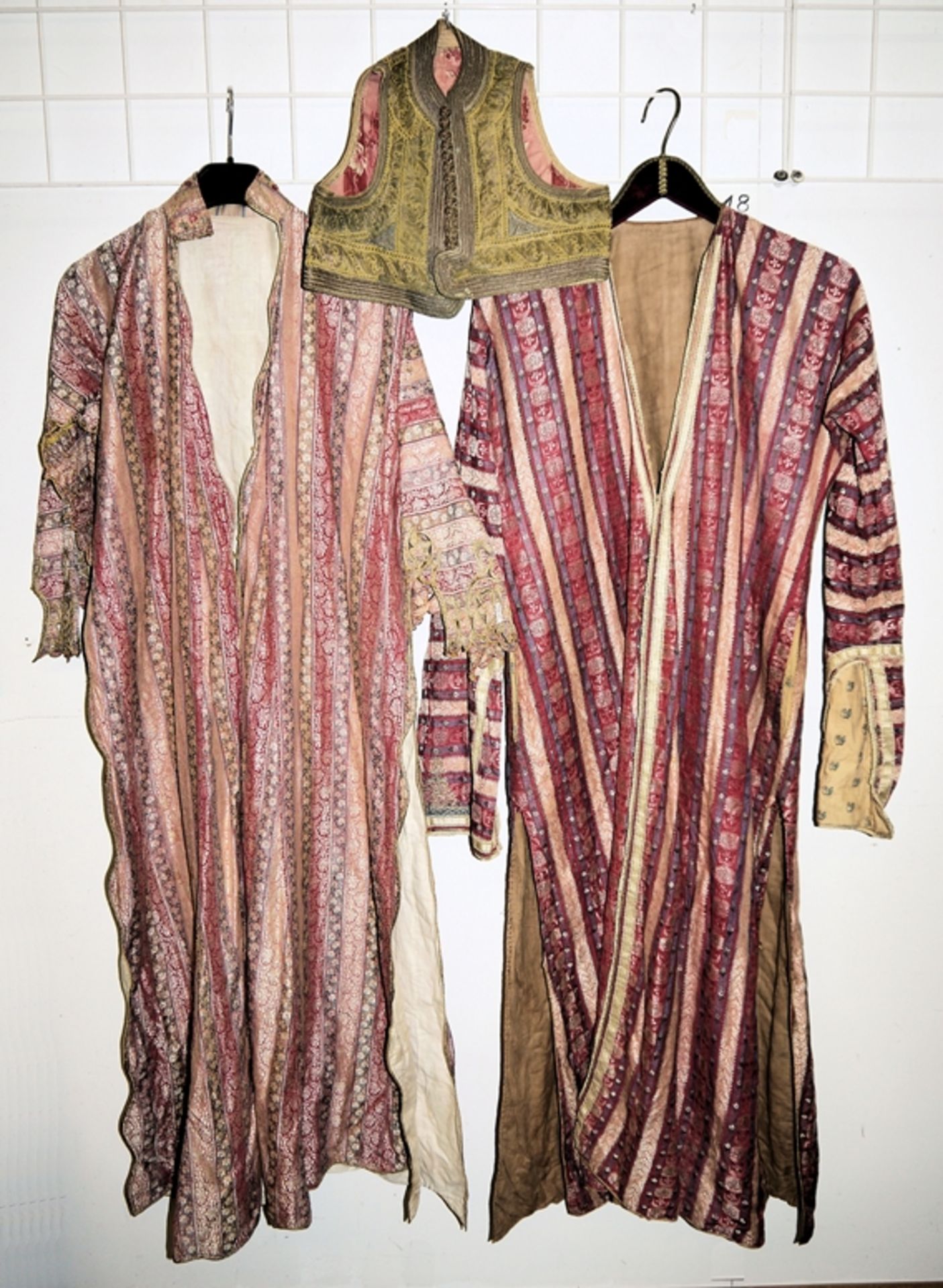 Two antique Indo-Pakistani silk caftans and a boy's waistcoat