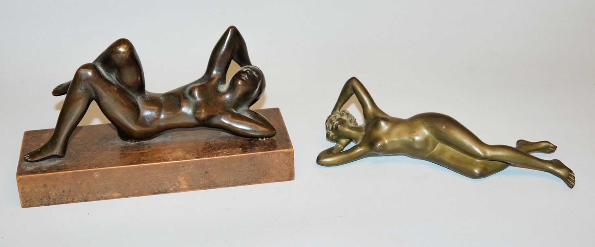 Two lolling female nudes, bronze sculptures c. 1920