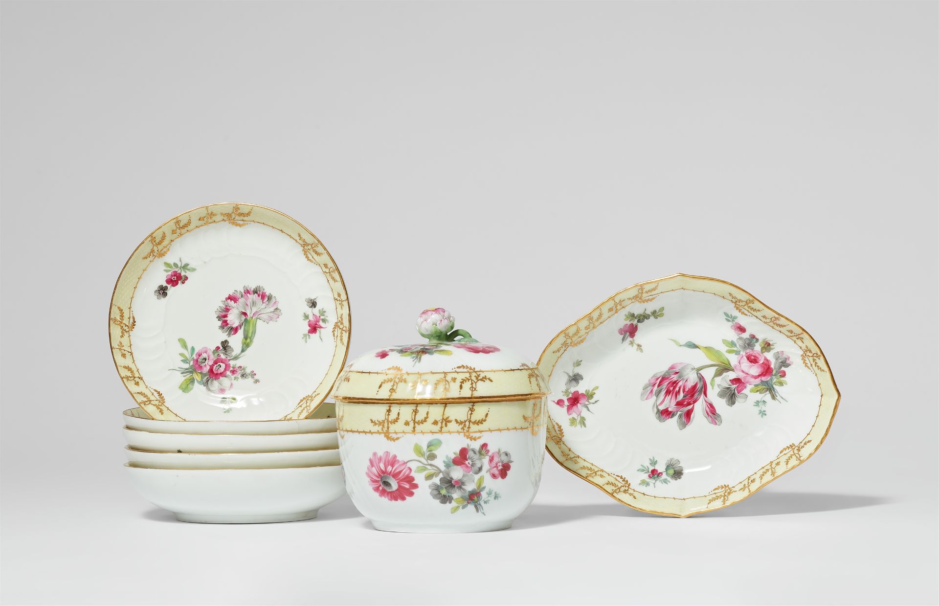 Seven Berlin KPM porcelain items from a coffee service with tri-coloured flowers