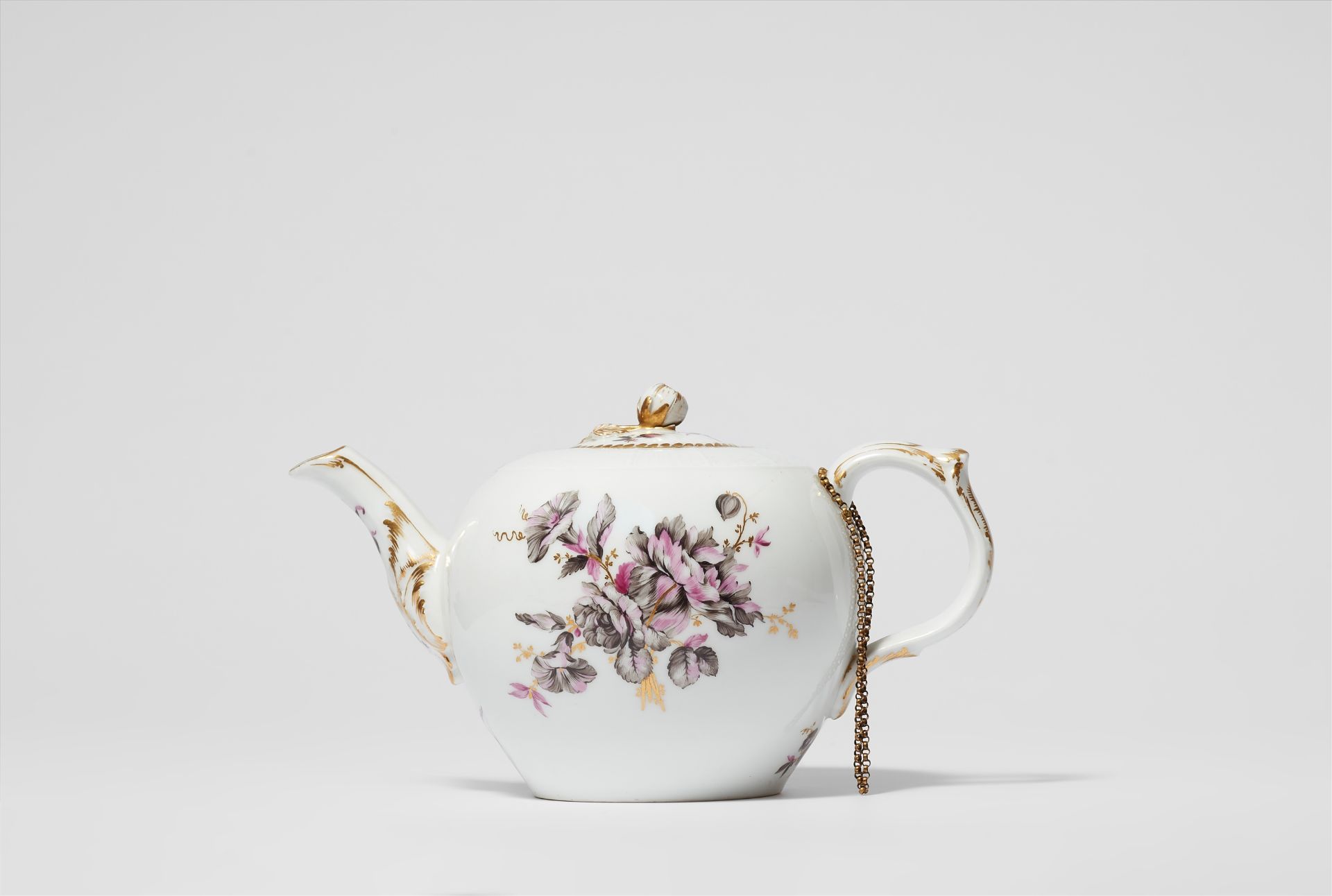 A Berlin KPM porcelain teapot with tri-coloured flowers