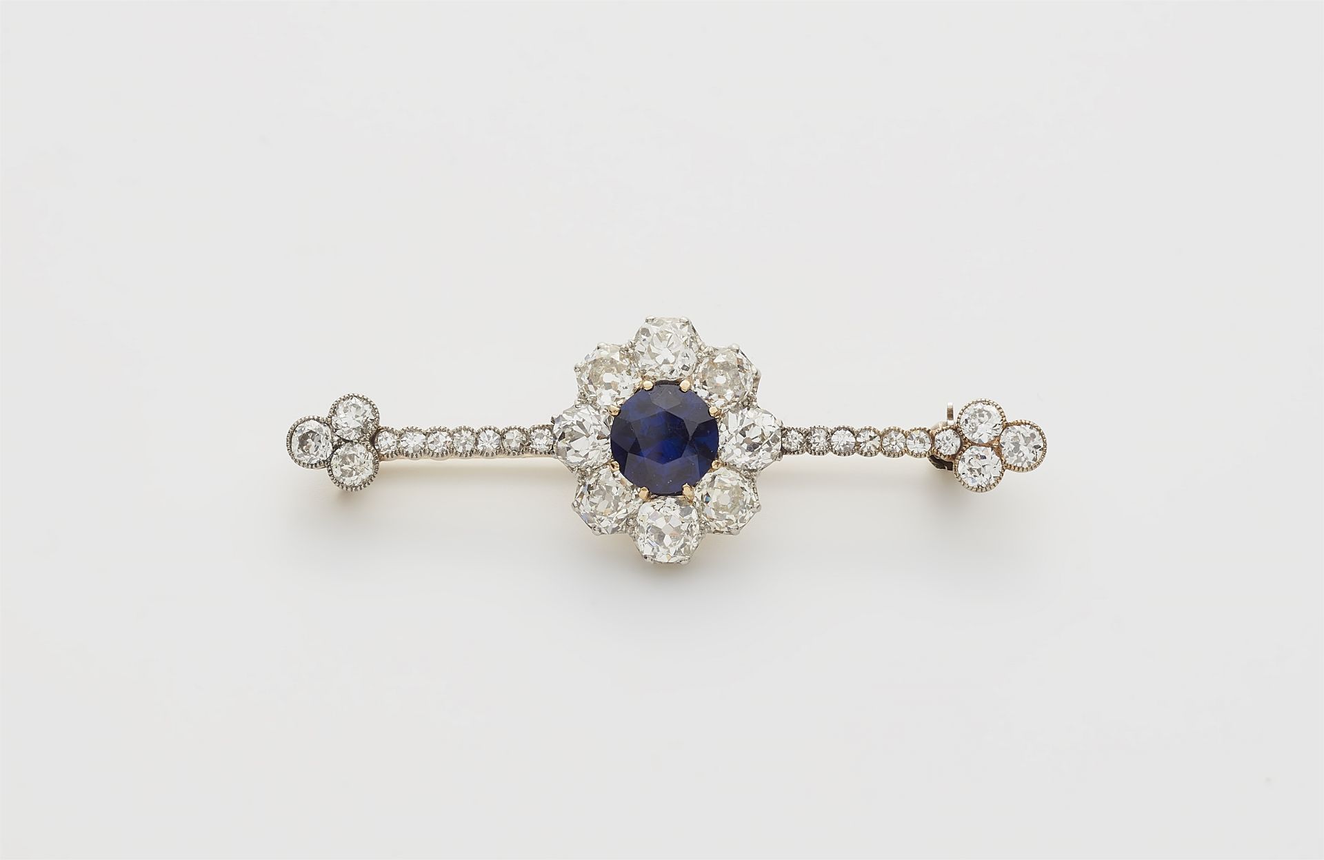 A Belle Epoque 14k gold diamond and synthetic "Verneuil" sapphire bar brooch.