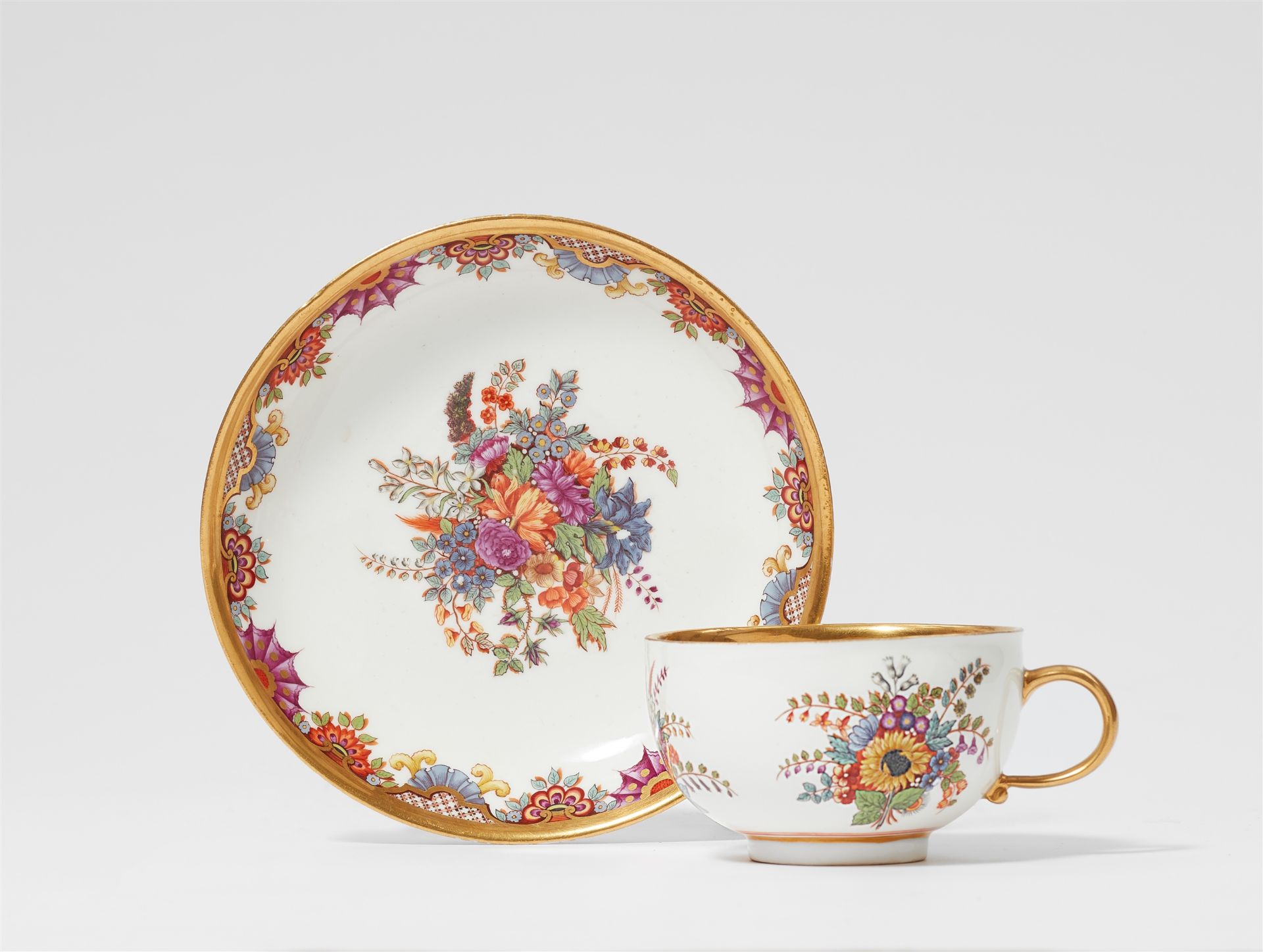 A Meissen porcelain cup and saucer with "hausmaler" decor