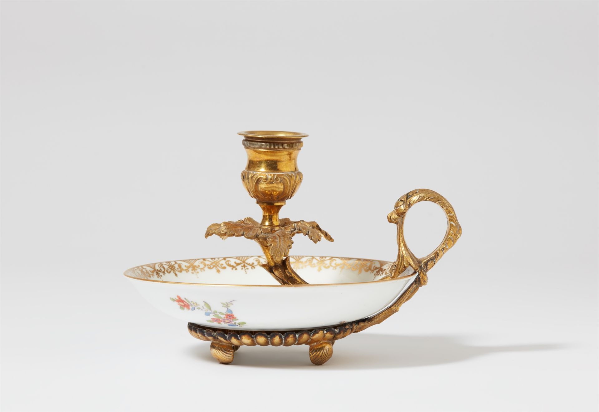 A Meissen porcelain chamberstick and saucer