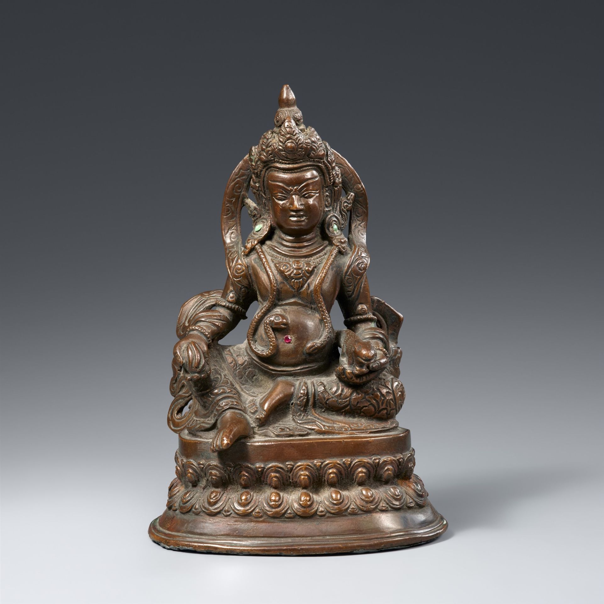 A Tibetan bronze figure of Jambhala. 19th/20th century