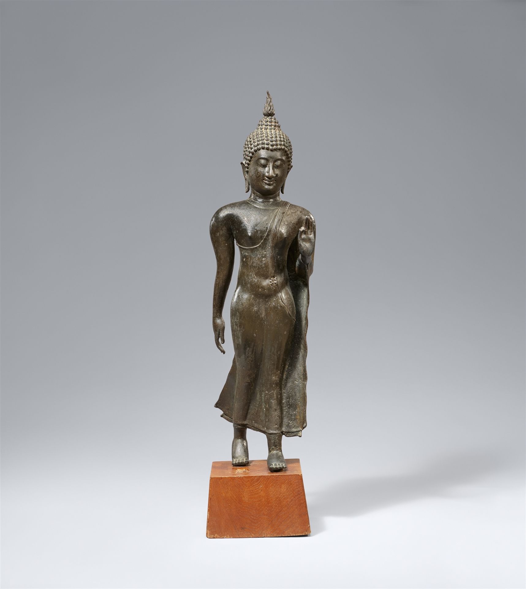 A Sukhothai-style bronze figure of a walking Buddha. Thailand. 14th century or later