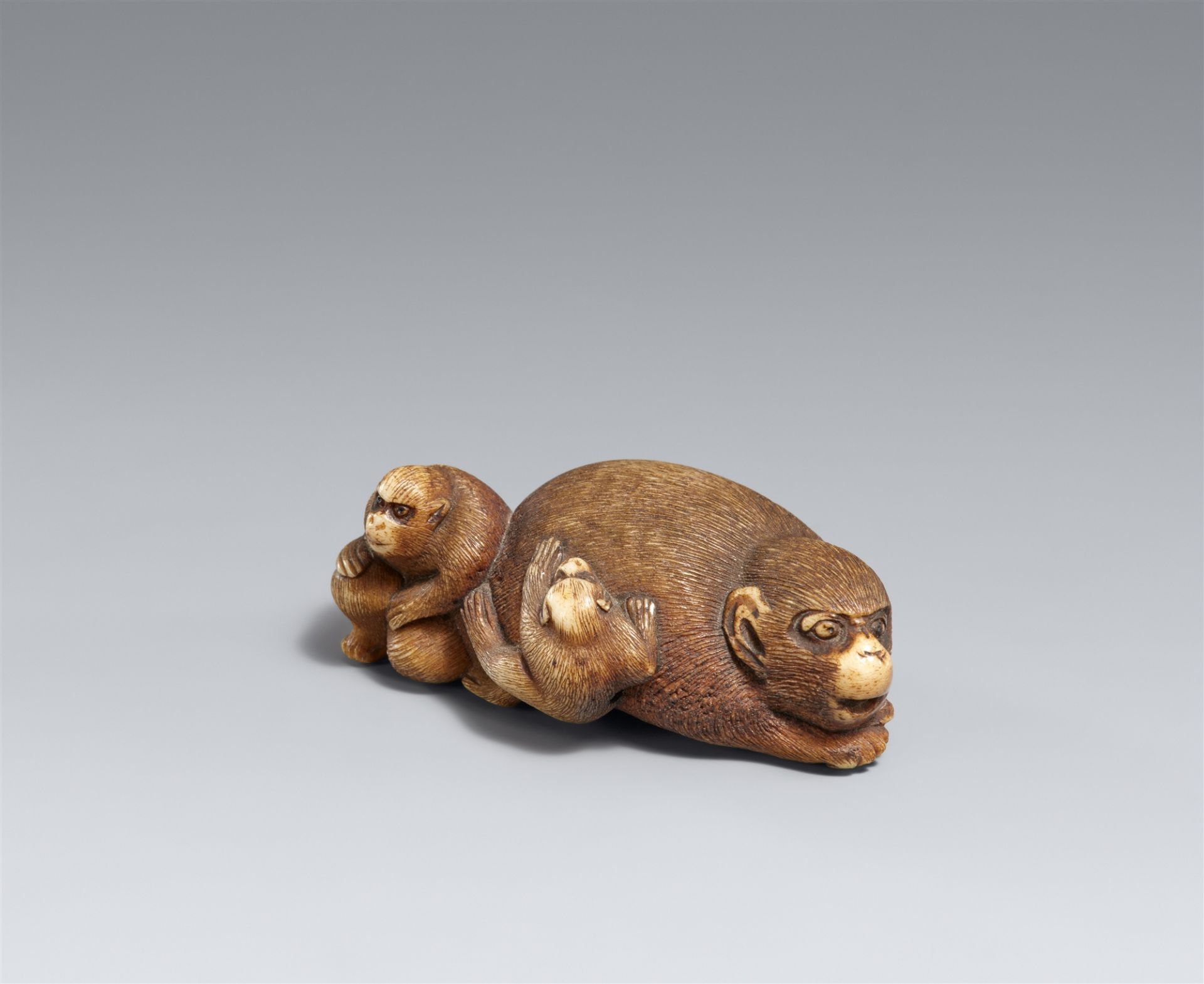 A stag antler netsuke of three monkeys. 19th century