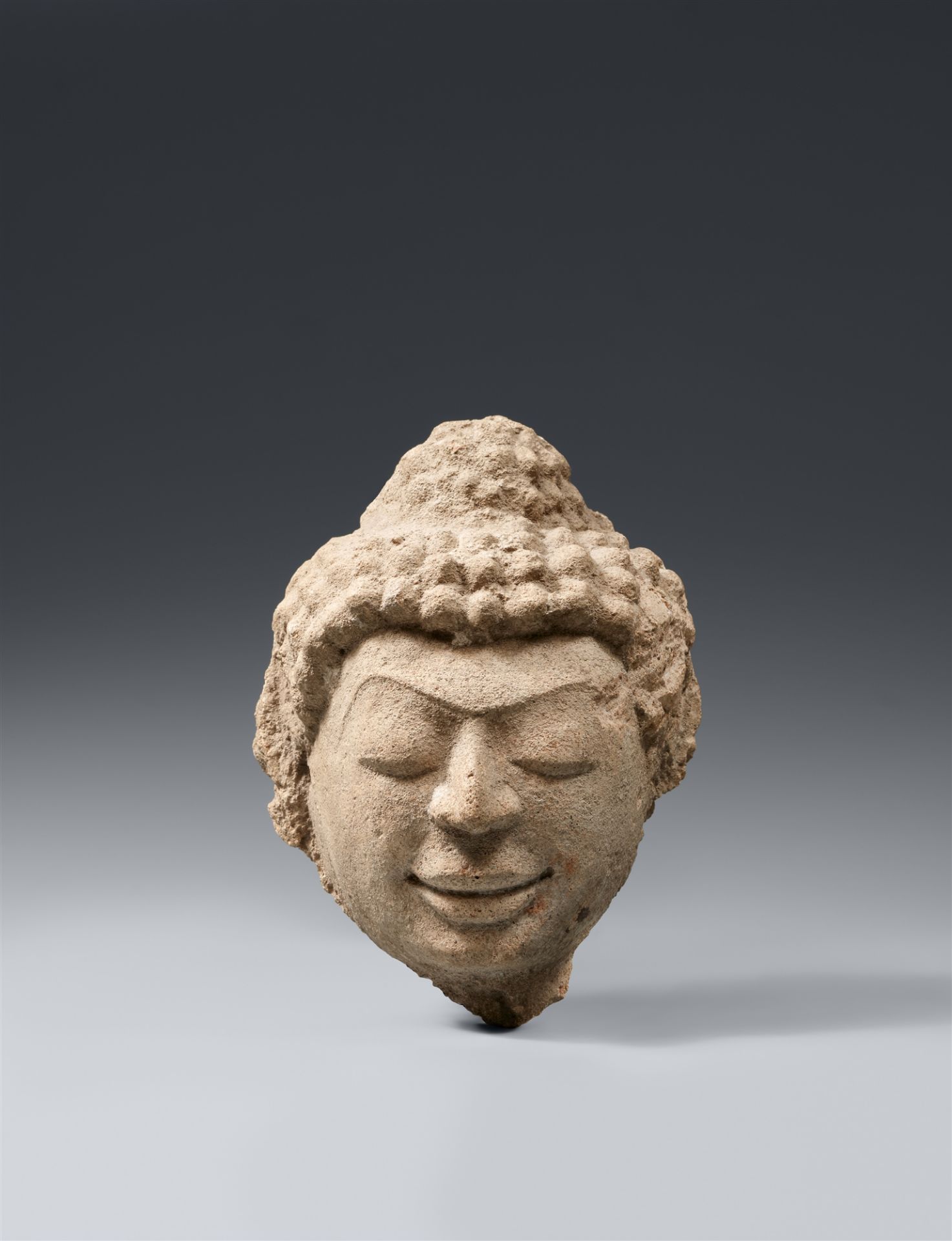 A Dvaravati stucco head of a Buddha. Thailand. 8th/9th century