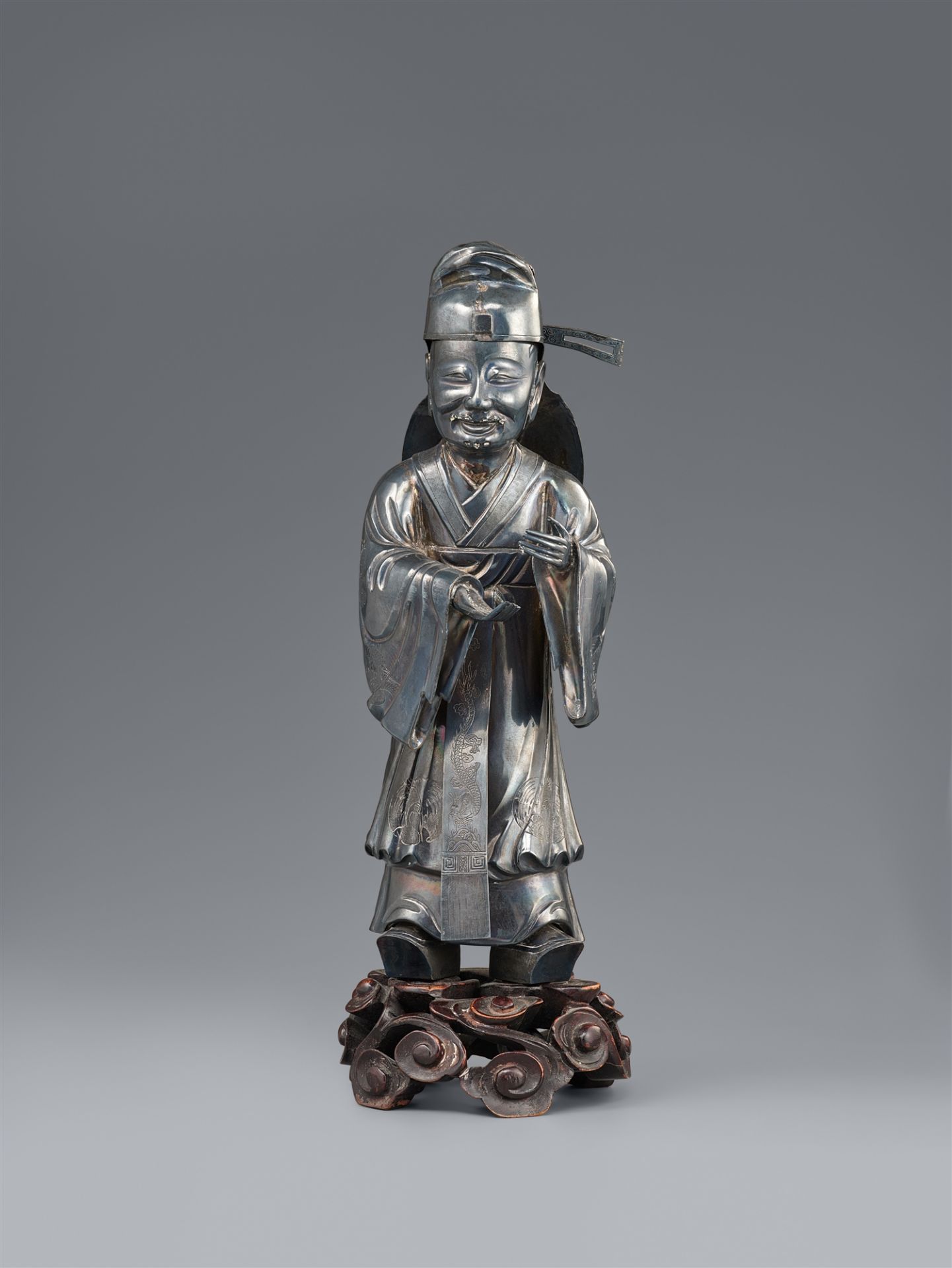 A hollow-cast silver figure of a dignitary. Probably Shanghai. Around 1900