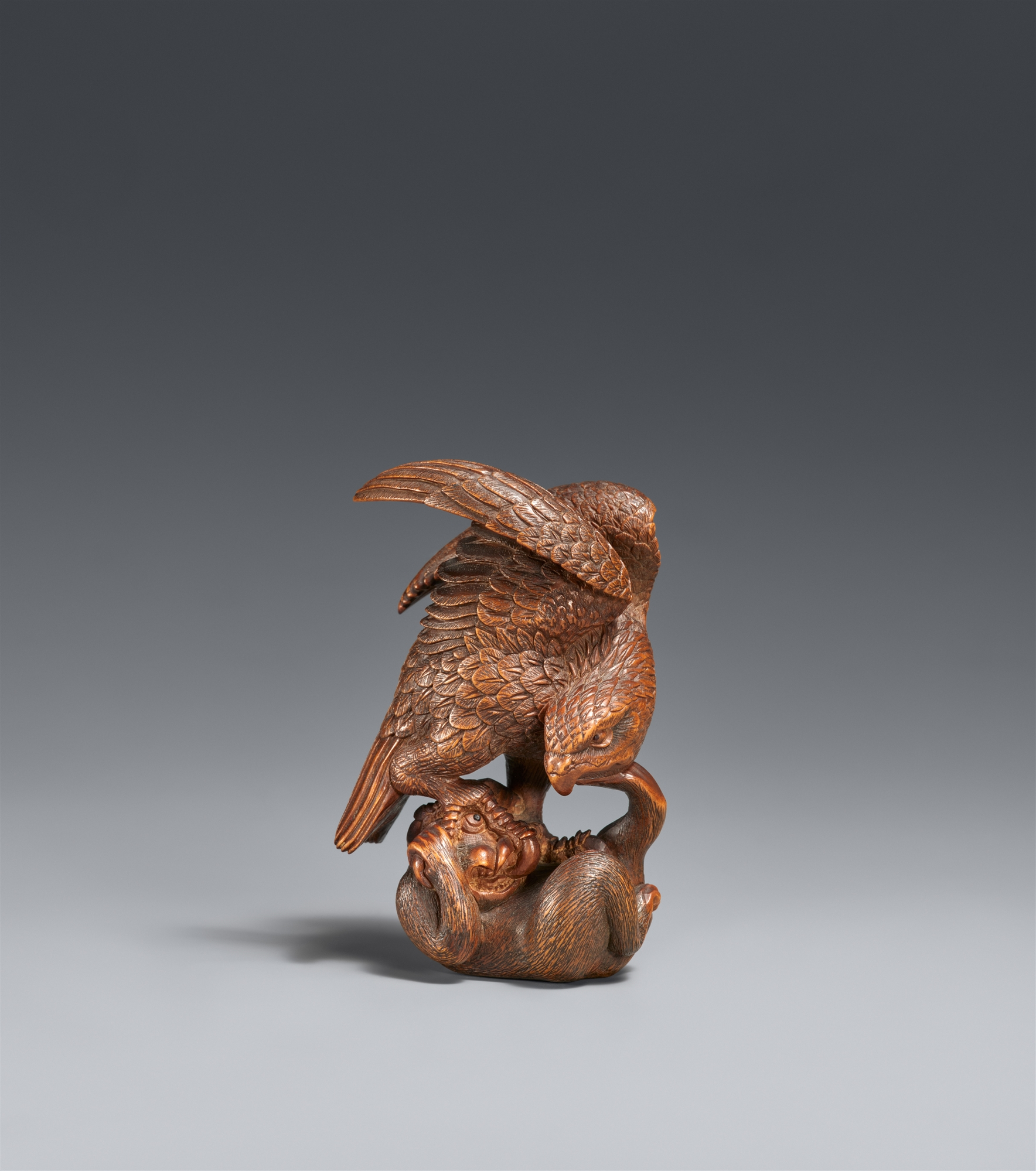 A boxwood okimono netsuke of an eagle and a monkey. Ise. Late 19th century