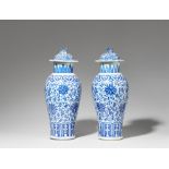 A pair of blue and white lidded baluster vases. Qing dynasty, 19th century