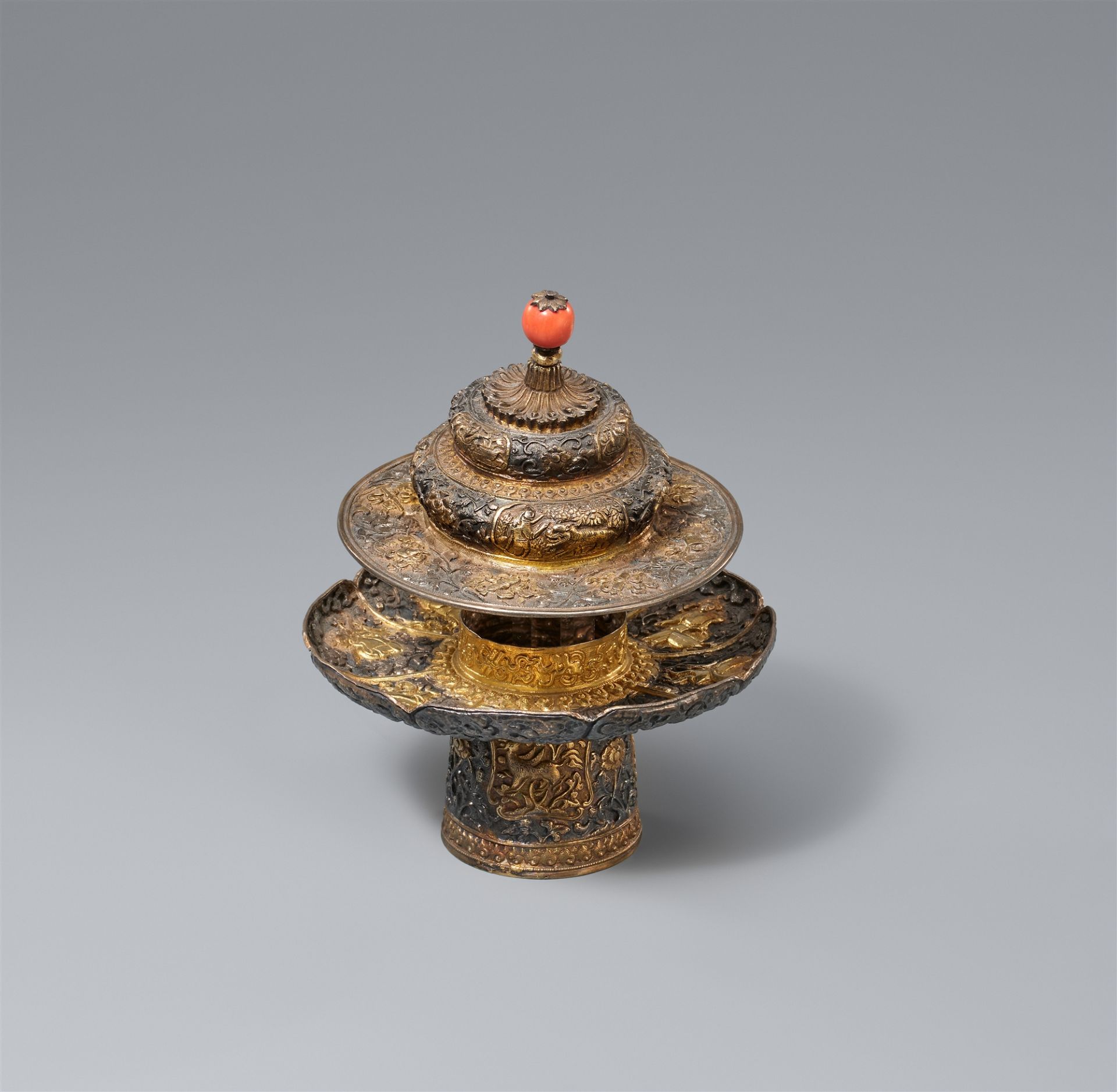 A Tibetan partly-gilt silver stand and lid for a bowl. 18th/19th century