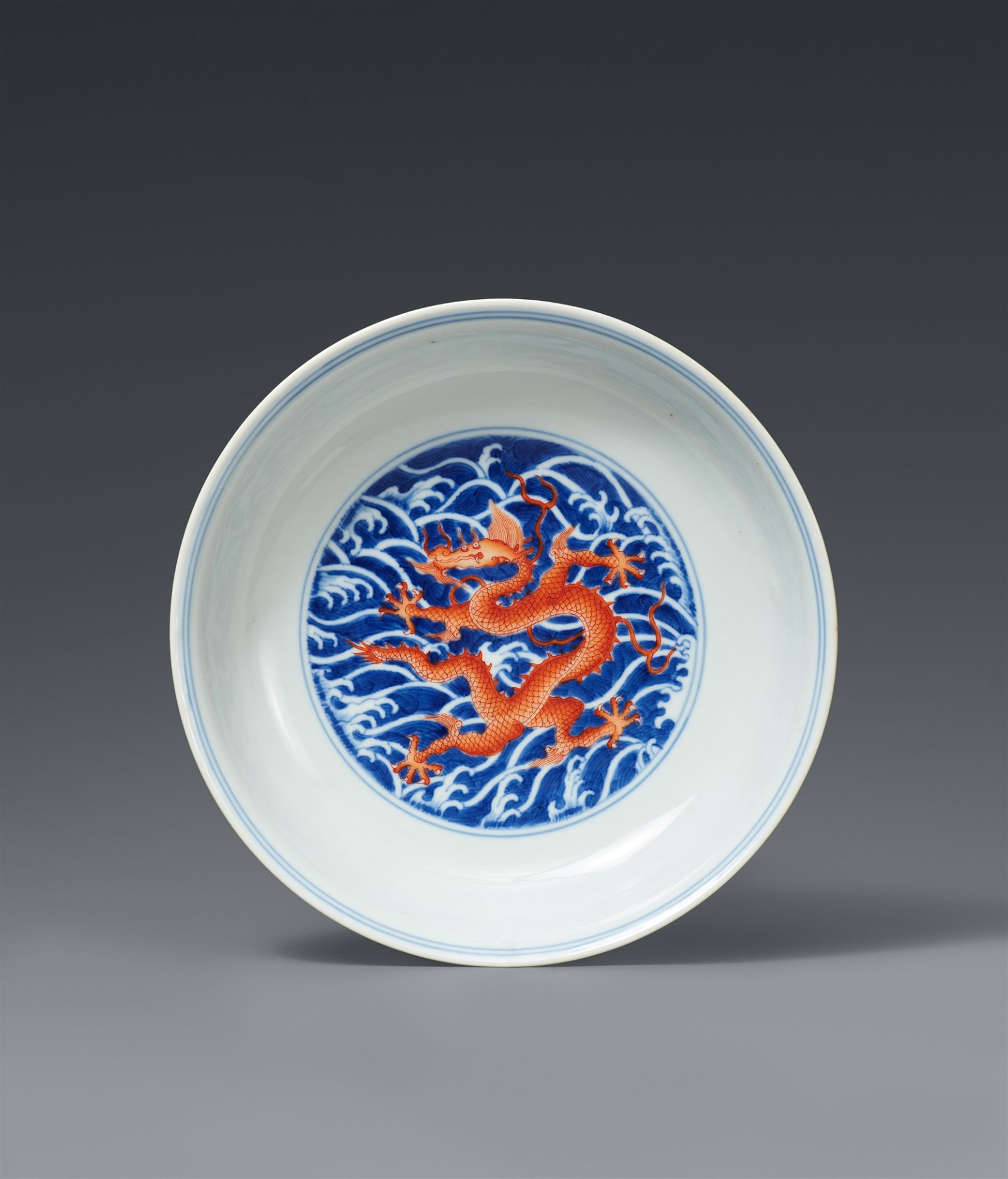 An imperial underglaze-blue and iron-red dragon dish. Qianlong six-character mark in underglaze-blue