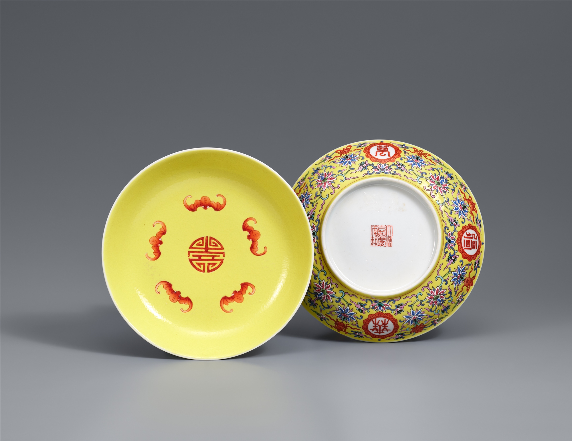 A pair of yellow-ground famille rose dishes. Jiaqing iron-red seal mark and possibly of the period (