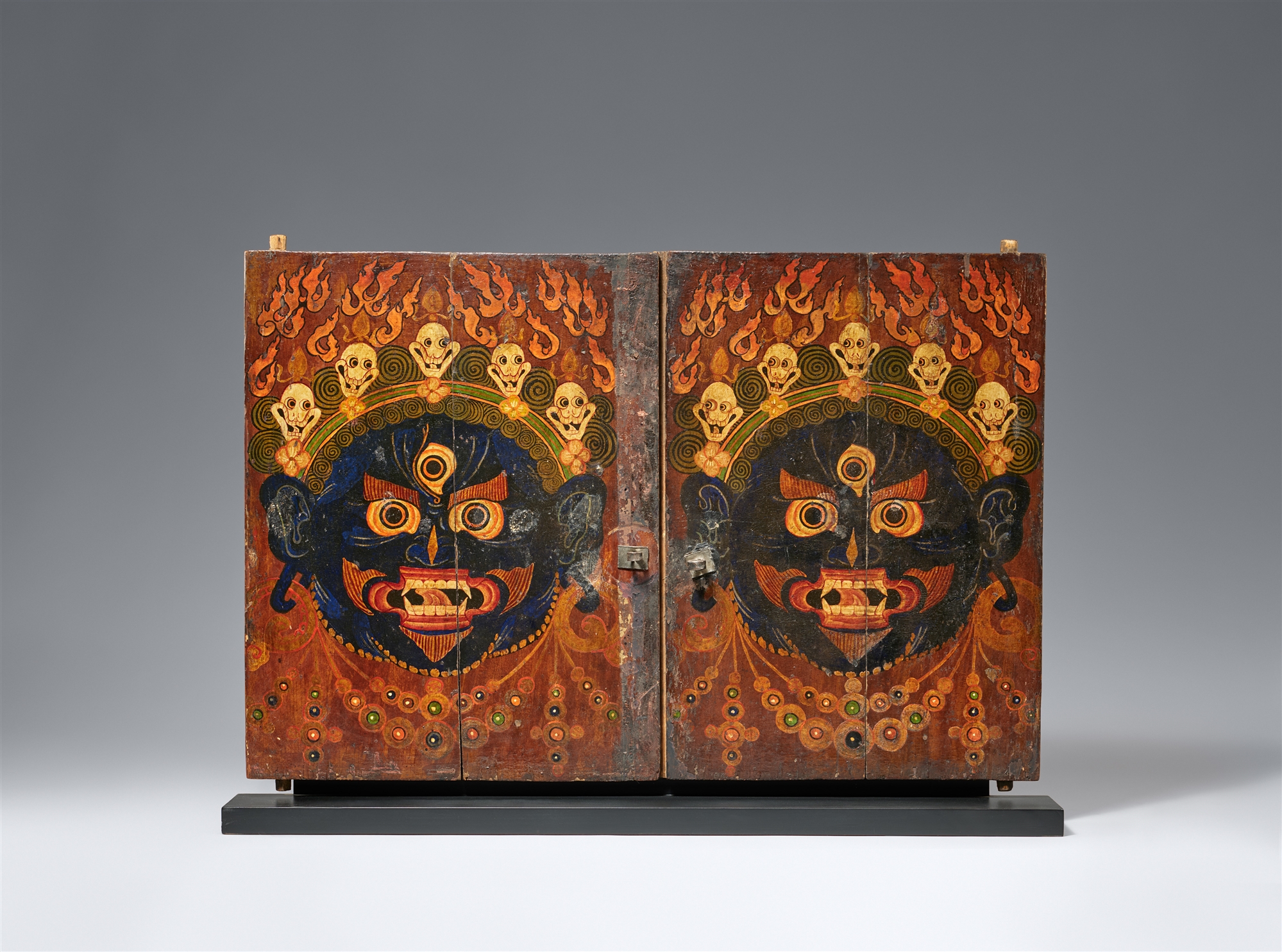 A pair of Tibetan wooden Torgam shrine-doors. Second half 19th century