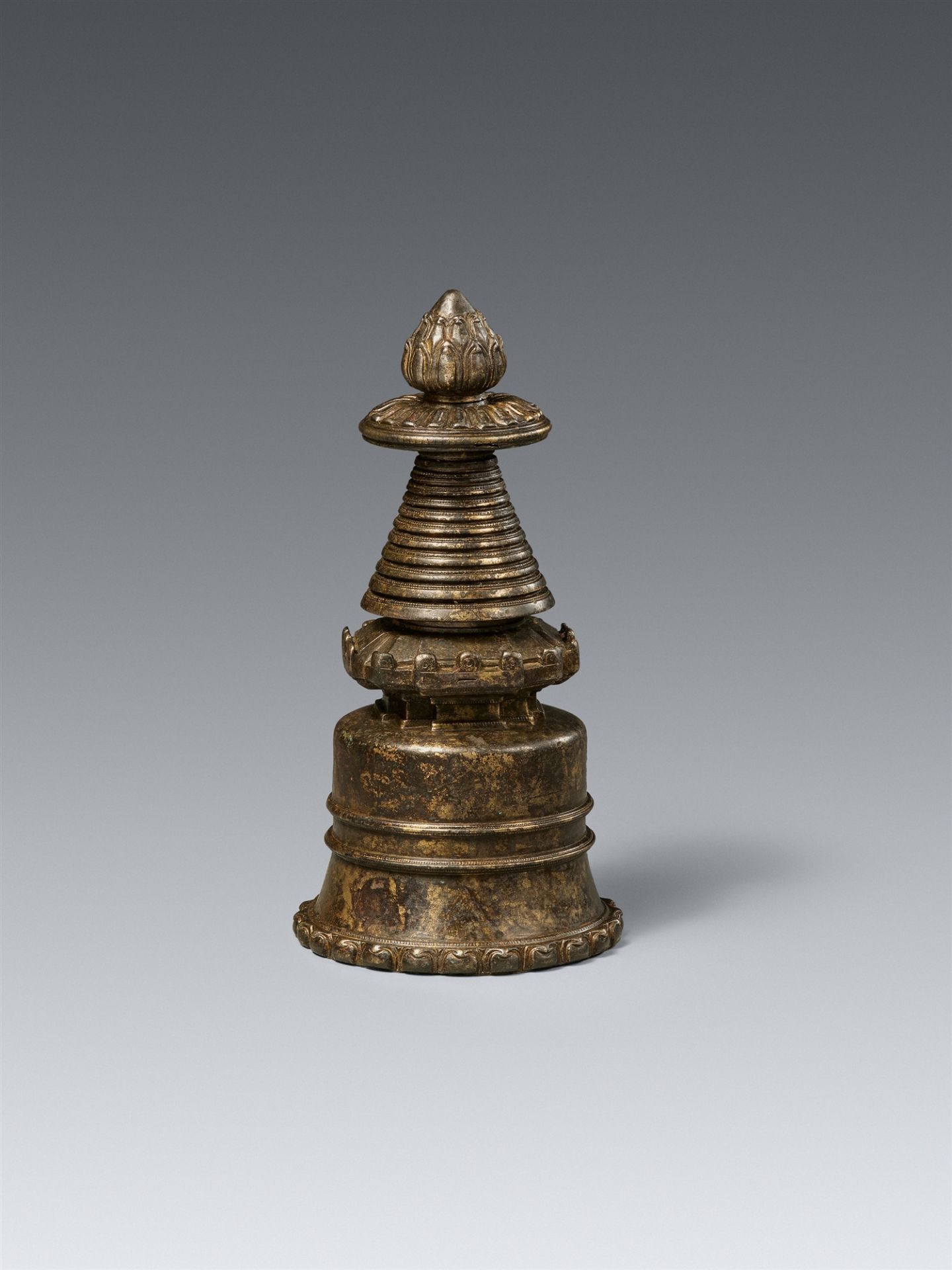 A Tibetan dark patinated copper alloy kadampa-stupa. 13th/14th century