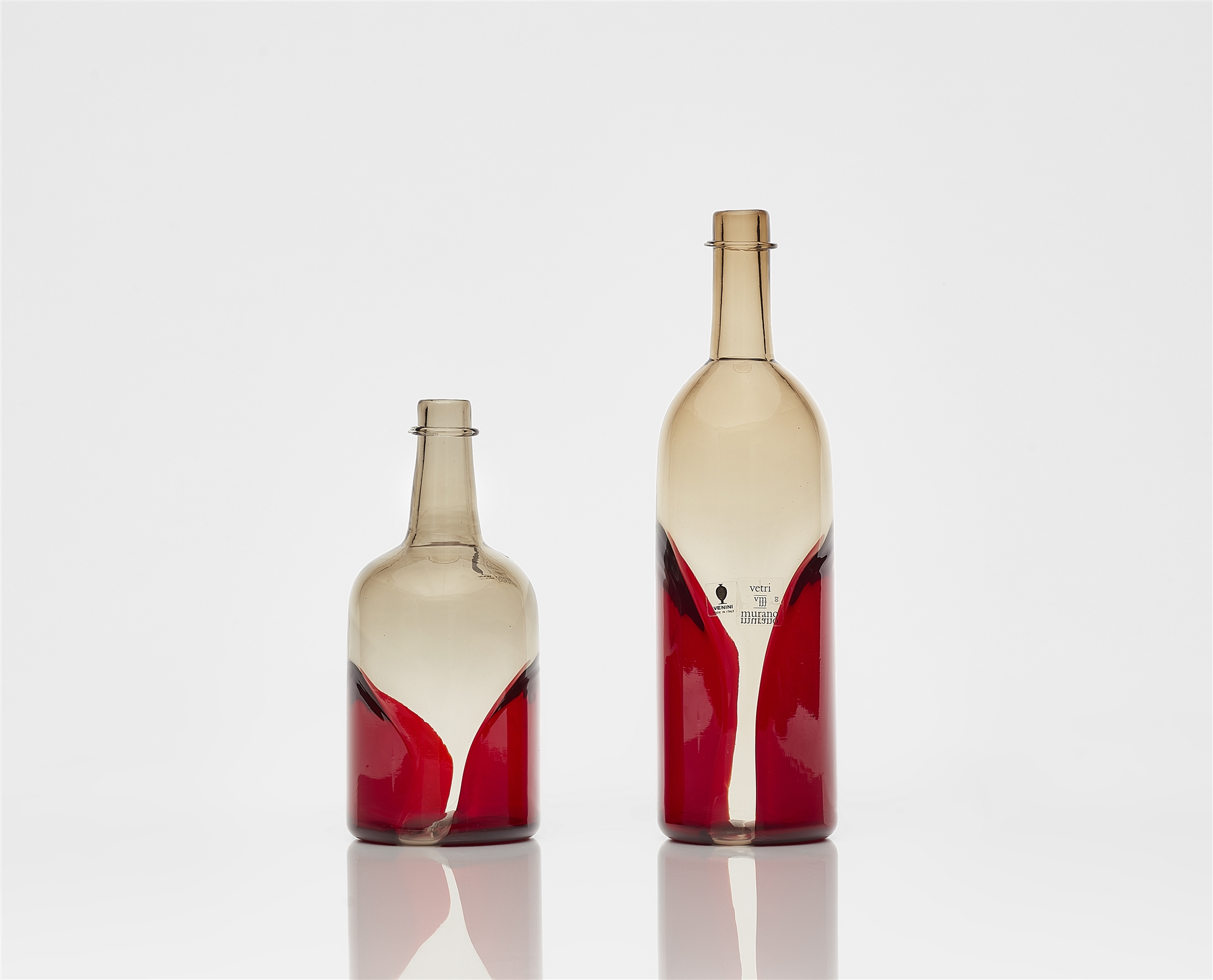 Two 'Pavoni' bottles, Venini & C., Murano, designed by Tapio Wirkkala, produced in 1982.