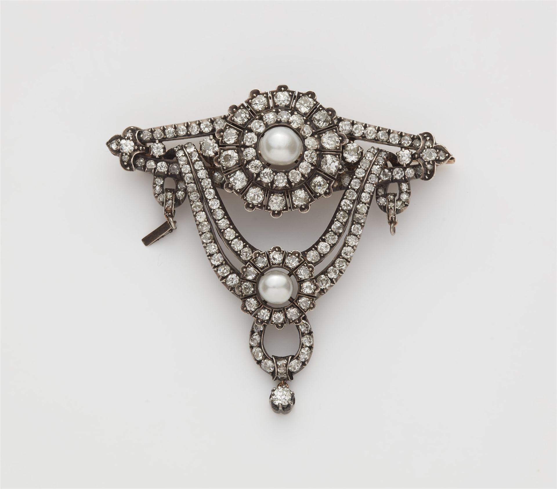 A late 19th century silver 14k red gold diamond and pearl garland brooch.