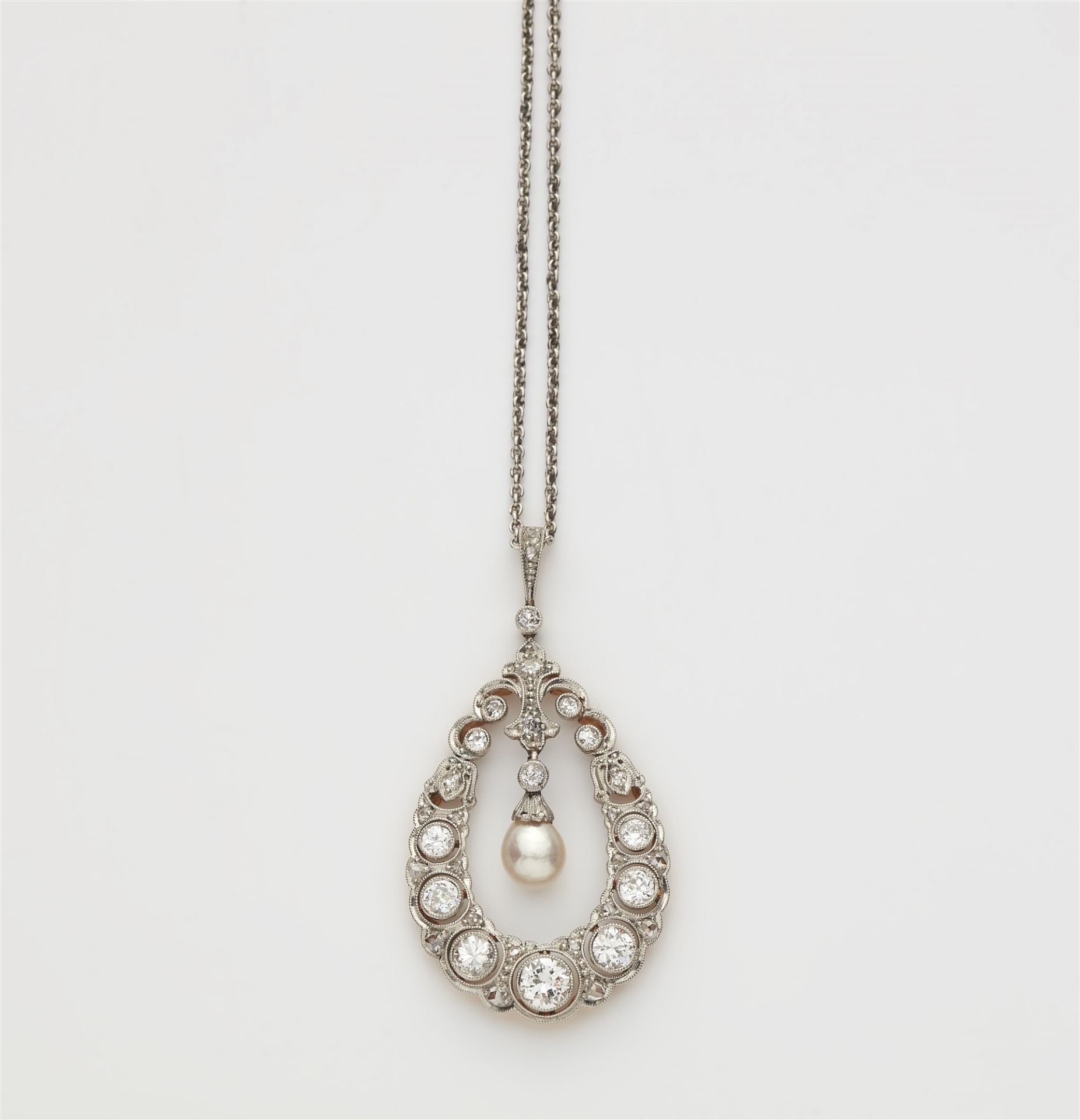 A platinum 14k gold diamond and natural pearl drop Belle Epoque pendant with a platinum chain.