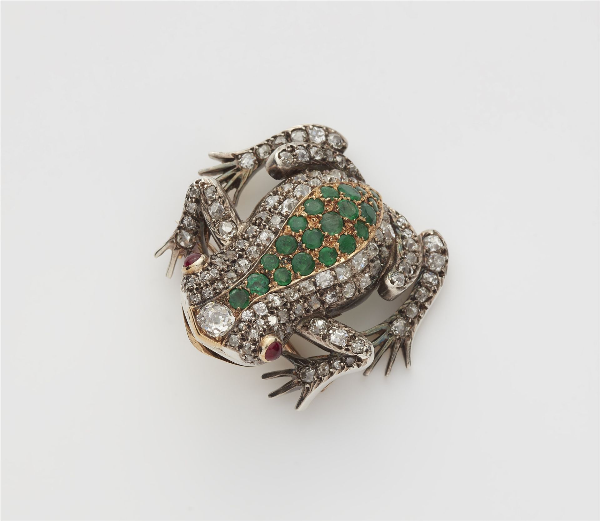 A silver 18k gold emerald and cushion cut diamond frog brooch.