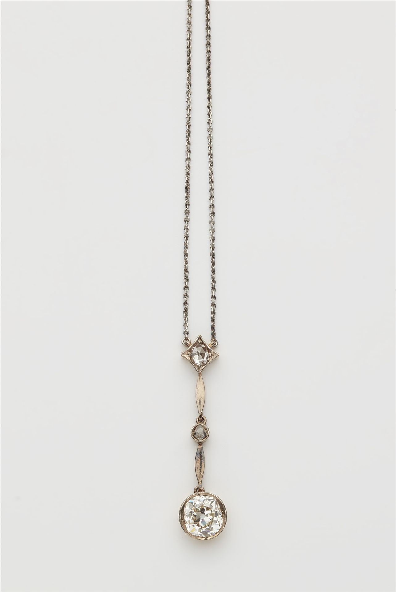 A Belle Epoque 14 kt gold platinum and European old-cut diamond solitaire pendant necklace.