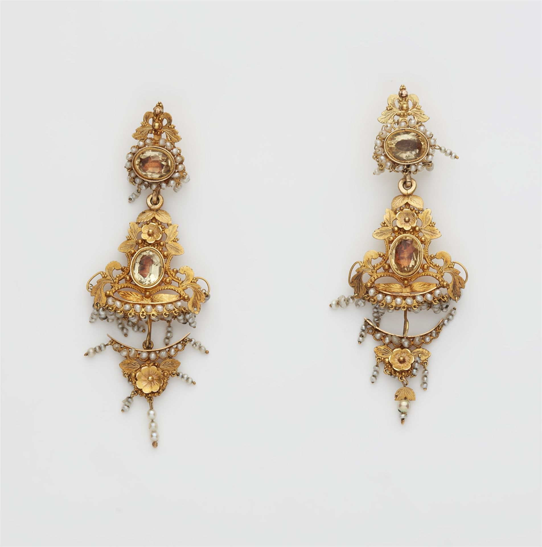 A pair of 18k gold filigree natural pearl and foiled paste dangling earrings.