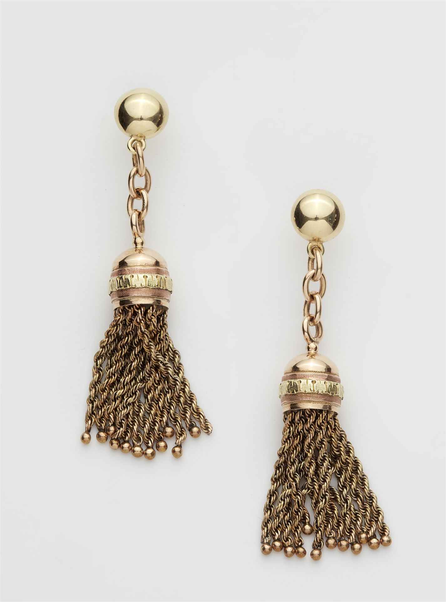 A pair of bicolour 14k gold tassel stud earrings.